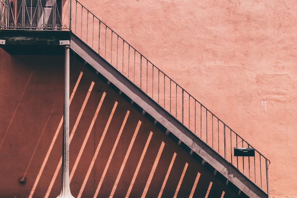 Staircase against peach-coloured wall